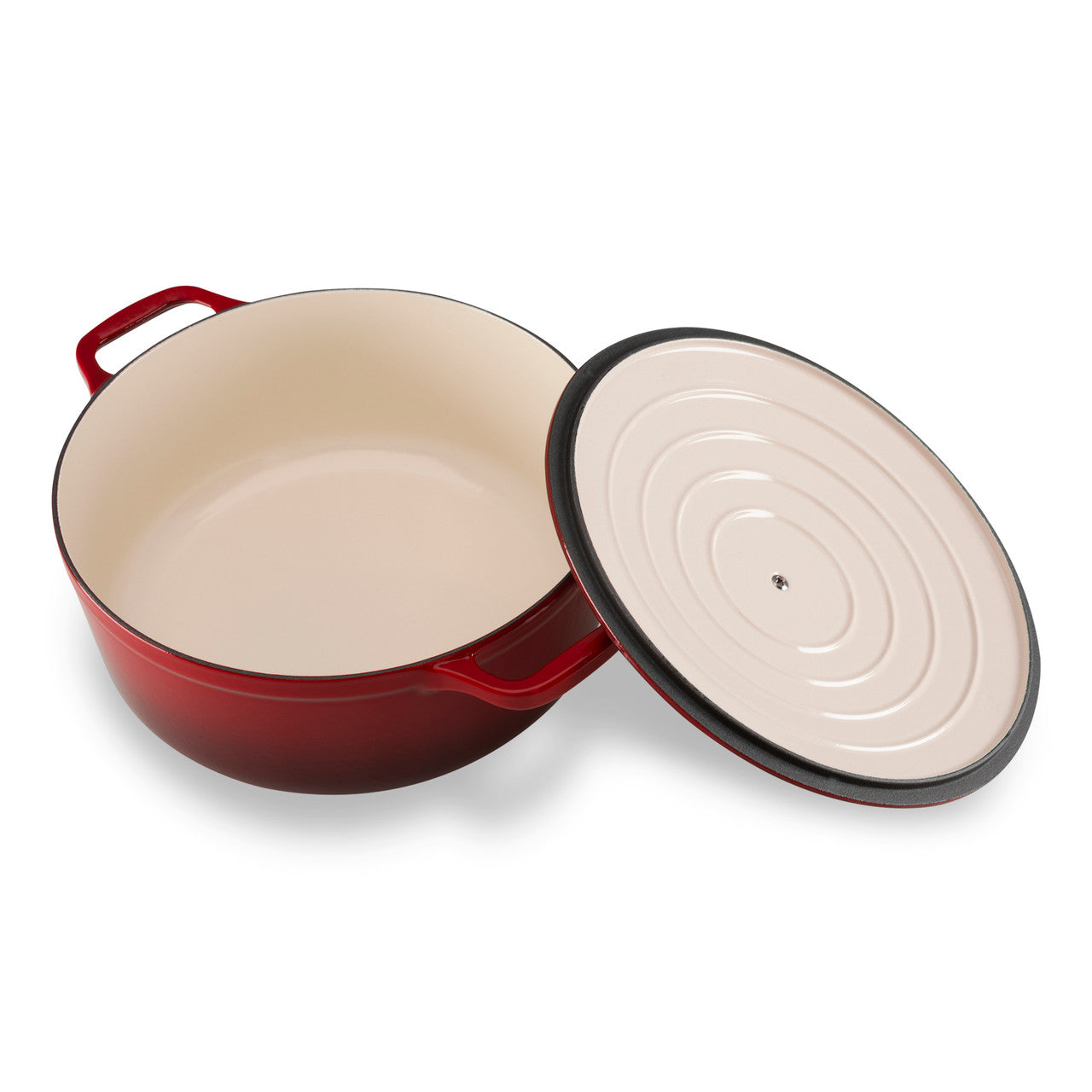 Red enameled cast iron Dutch oven with beige interior and lid on a white background